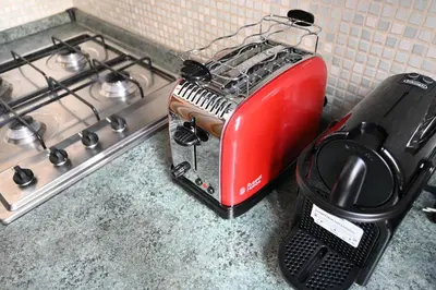 a red toaster sitting on a counter next to a stove at Pantheon Boutique Apartment 