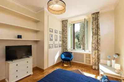a living room with a blue couch and a television at Ludovisi by Rental in Rome in Rome