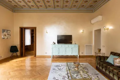 a living room with a couch and a tv at Ludovisi by Rental in Rome in Rome