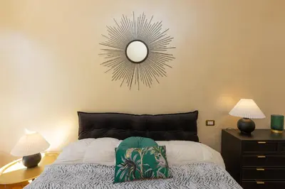 a bedroom with a bed with a mirror on the wall at Ludovisi by Rental in Rome in Rome