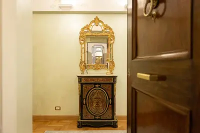 a mirror on a wall next to a door at Ludovisi by Rental in Rome in Rome