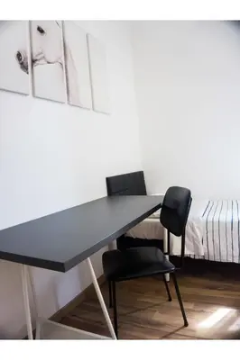a table and two chairs in a room at Cosmo GuestHouse in Rome