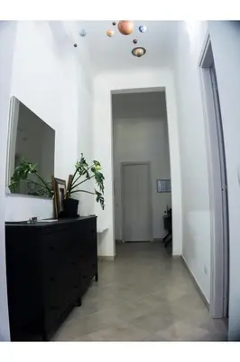 a hallway with a dresser and a mirror on a wall at Cosmo GuestHouse in Rome