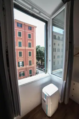 a window with a view of a building at Cosmo GuestHouse in Rome