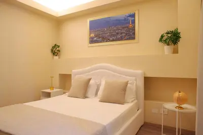 a bedroom with a white bed and a window at Musa Rooms Roma in Rome