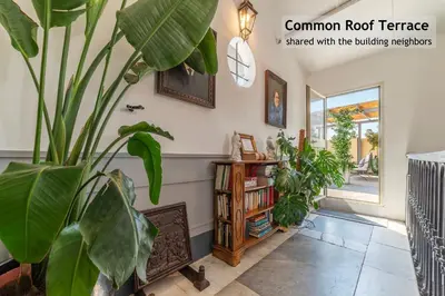 a living room with plants and a book shelf at Toscana 1 - FromHometoRome in Rome