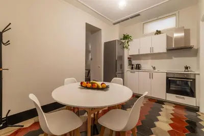 a kitchen with a table and chairs in a room at Toscana 1 - FromHometoRome in Rome