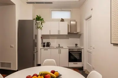 a kitchen with a table with a bowl of fruit on it at Toscana 1 - FromHometoRome in Rome