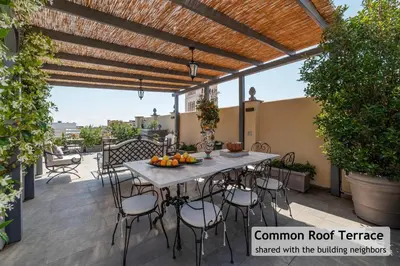 a patio with a table and chairs on a deck at Toscana 1 - FromHometoRome in Rome