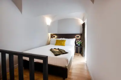 a bedroom with a bed with a yellow pillow at Piazza di Spagna 66 Luxury Apartment - Maison D'Art Collection in Rome