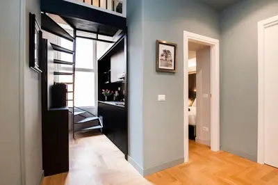 a small apartment with a staircase in a room at Piazza di Spagna 66 Luxury Apartment - Maison D'Art Collection in Rome