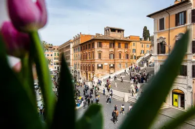 a group of people walking down stairs in a city at Piazza di Spagna 66 Luxury Apartment - Maison D'Art Collection in Rome