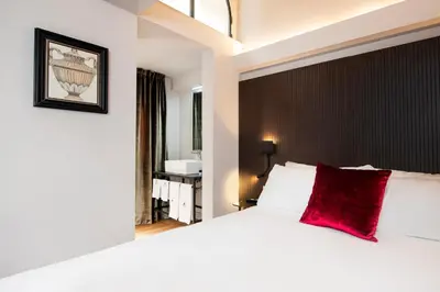 a bedroom with a large white bed with a red pillow at Piazza di Spagna 66 Luxury Apartment - Maison D'Art Collection in Rome