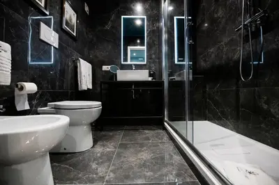 a bathroom with a toilet and a sink and a shower at Piazza di Spagna 66 Luxury Apartment - Maison D'Art Collection in Rome
