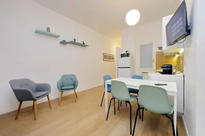 a dining room with a table and four chairs at suity I cozy segesta apartment in Rome