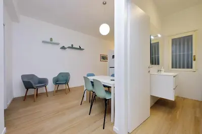 a dining room with a table and chairs at suity I cozy segesta apartment in Rome