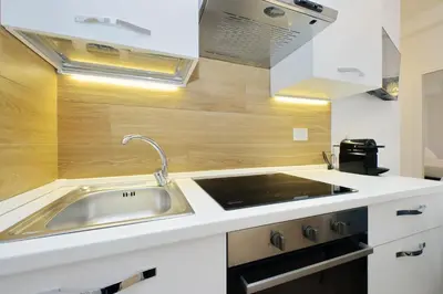 a kitchen with a sink and a stove at suity I cozy segesta apartment in Rome
