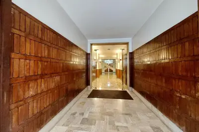 a hallway with wood paneled walls and a hallway with a door at suity I cozy segesta apartment in Rome