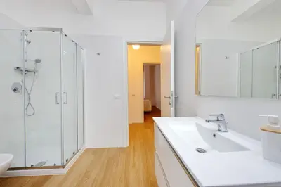 a white bathroom with a shower and a sink at suity I cozy segesta apartment in Rome