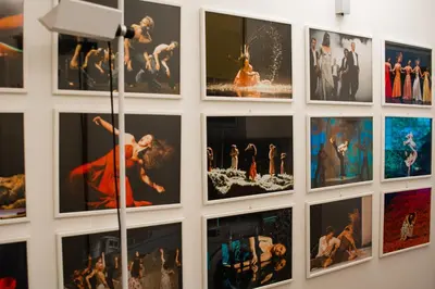 a wall full of pictures of dancers in a museum at Traversari 27 in Rome