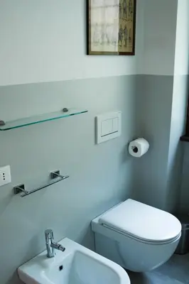 a white bathroom with a toilet and a sink at Traversari 27 in Rome