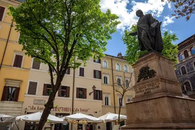 a statue of a man standing in front of a building at Navona Sky Palace in Rome