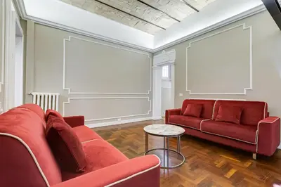 a living room with two red couches and a table at SPANISH GARDEN in Rome