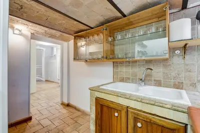 a kitchen with a sink and wooden cabinets at SPANISH GARDEN in Rome