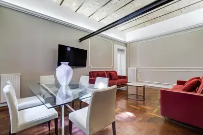 a dining room with a glass table and red chairs at SPANISH GARDEN in Rome