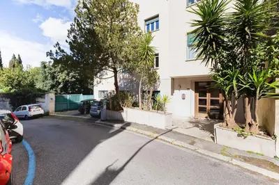a house with cars parked on the side of a street at Classy Apartment - Auditorium & Villa Borghese in Rome