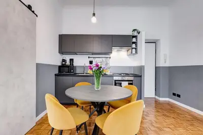 a kitchen with a table and yellow chairs at Classy Apartment - Auditorium & Villa Borghese in Rome