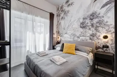 a bedroom with a large bed with yellow pillows at Classy Apartment - Auditorium & Villa Borghese in Rome