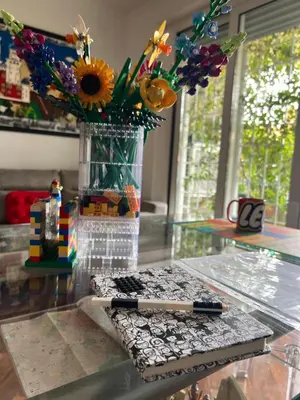 a glass table with a pen and a vase with flowers at Cip's Brickhouse in Rome