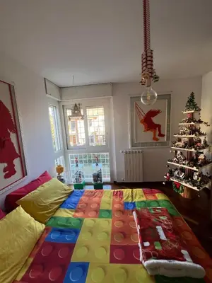 a room with a christmas tree and a colorful blanket at Cip's Brickhouse in Rome