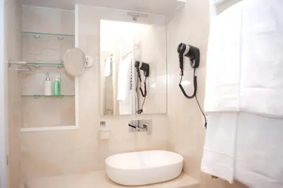 a bathroom with a toilet and a phone on the wall at SCIPIO92HOME in Rome