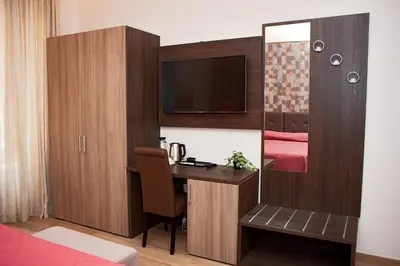 a hotel room with a desk and a tv at SCIPIO92HOME in Rome