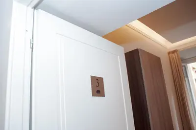 a white door with a light switch on it at SCIPIO92HOME in Rome