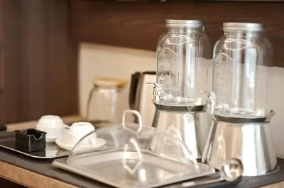 a kitchen counter with glass jars and a sink at SCIPIO92HOME in Rome