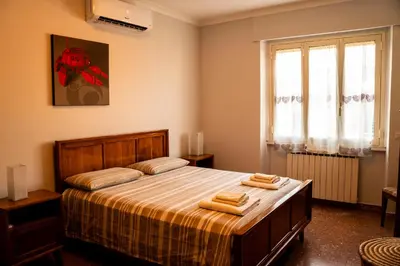 a bedroom with a bed with two towels on it at Casa Marta in Rome
