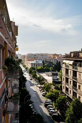 a city street with parked cars and buildings at Casa Marta in Rome