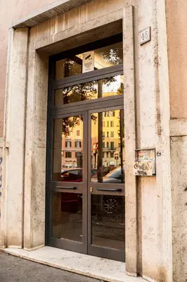 a glass door of a building with a car in it at Casa Marta in Rome