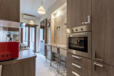 a kitchen with a stove and a counter top at Naima Apartment San Pietro in Rome