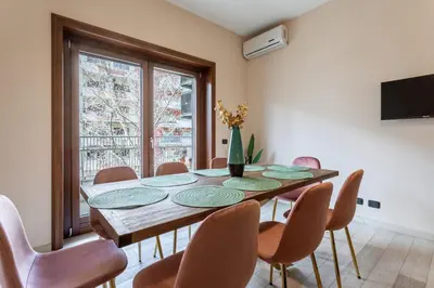 a dining room with a table and chairs at Naima Apartment San Pietro in Rome