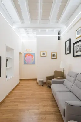 a living room with a couch and a table at Lupa Luxury Apartment in Rome