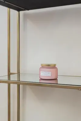 a pink candle sitting on a glass shelf at Lupa Luxury Apartment in Rome