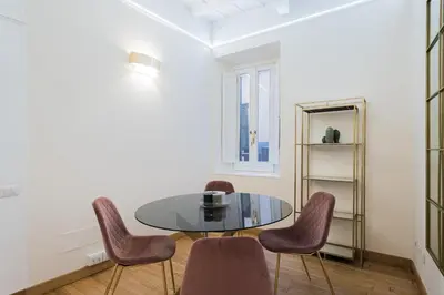 a dining room with a glass table and purple chairs at Lupa Luxury Apartment in Rome