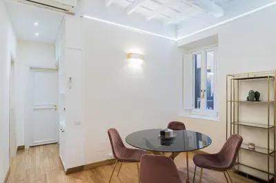 a dining room with a table and chairs at Lupa Luxury Apartment in Rome