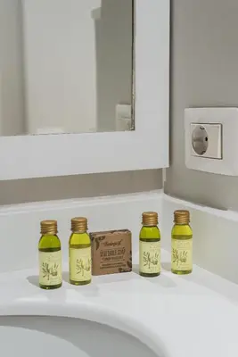 a bathroom sink with four jars on a counter at Lupa Luxury Apartment in Rome