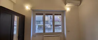 a window in a room with a radiator and lights at Apartment Nonna Anna in Rome