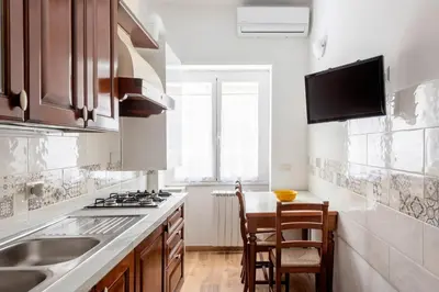 a kitchen with a sink and a stove top oven at Apartment Nonna Anna in Rome